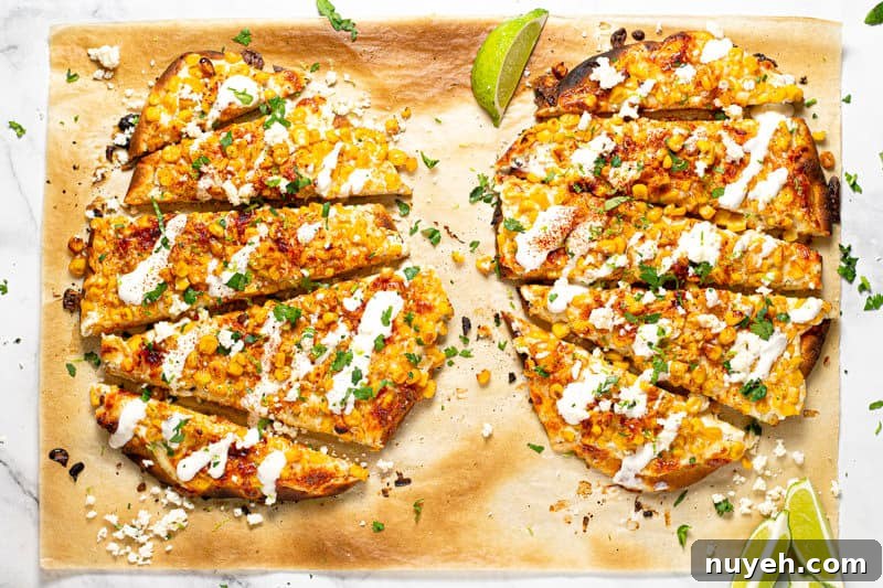 Overhead shot of two Mexican street corn flatbreads garnished with fresh chopped cilantro 