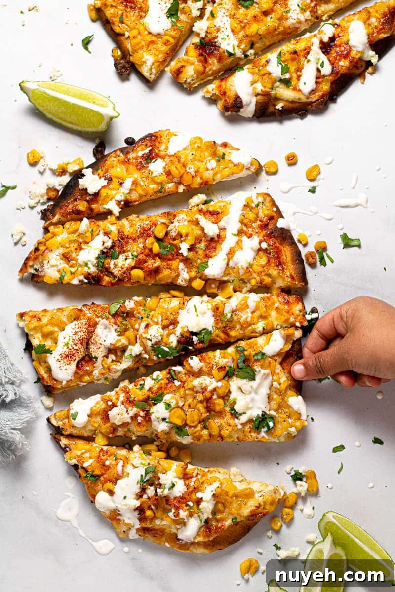 Overhead shot of Mexican street corn flatbread garnished with fresh chopped cilantro 