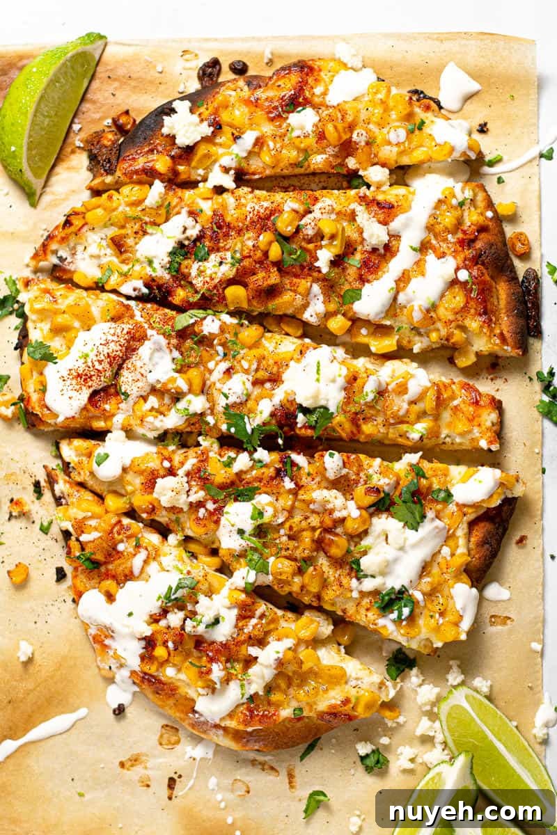 Overhead shot of Mexican street corn pizza garnished with fresh chopped cilantro 