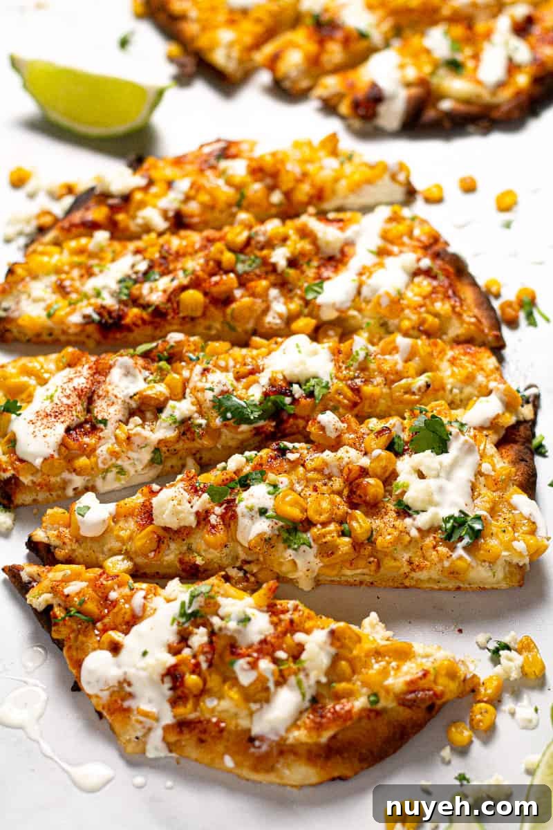 Close up shot of Mexican street corn pizza garnished with fresh chopped cilantro 