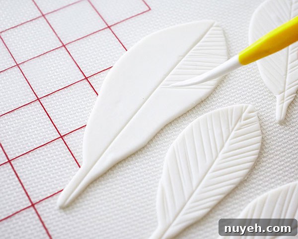 How to Make Cupcakes with Edible Gold Feathers 6 DIY Gold Feather Cupcakes | a cake tutorial by Cakegirls for TheCakeBlog.com