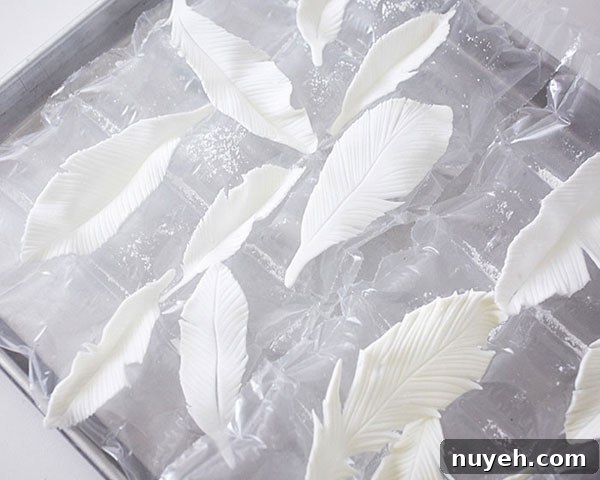 How to Make Cupcakes with Edible Gold Feathers 8 DIY Gold Feather Cupcakes | a cake tutorial by Cakegirls for TheCakeBlog.com