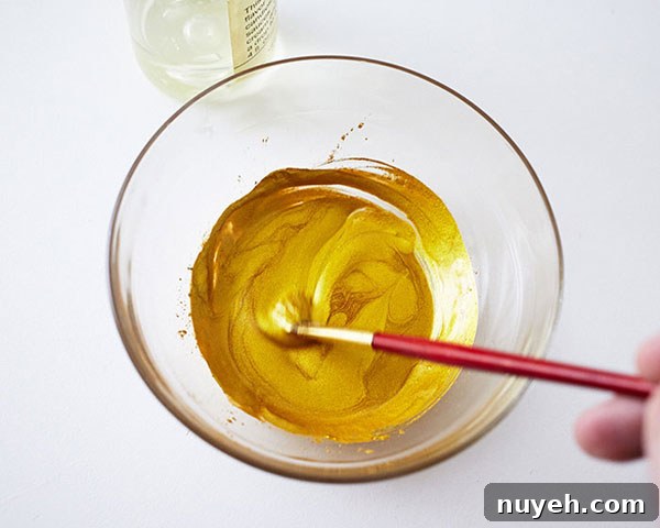 How to Make Cupcakes with Edible Gold Feathers 9 DIY Gold Feather Cupcakes | a cake tutorial by Cakegirls for TheCakeBlog.com