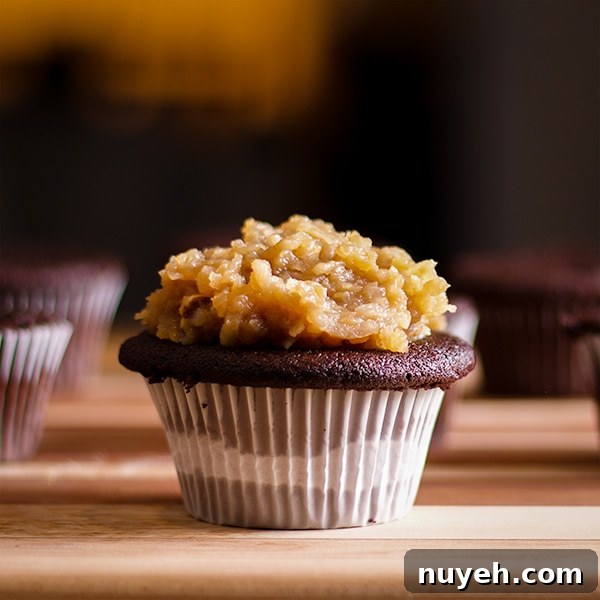 A German Chocolate Cupcake topped with caramel coconut and pecan topping.