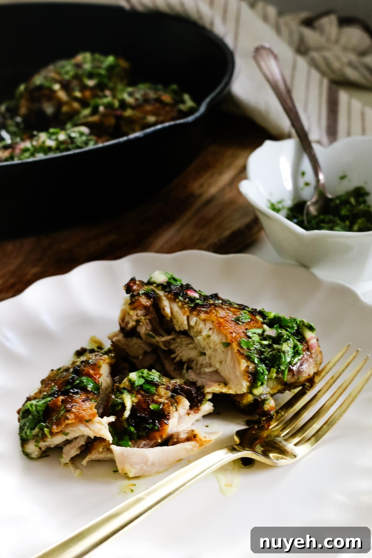 Grilled Chimichurri Chicken Thighs Recipe 10 chimichurri chicken thighs on a plate with a fork.