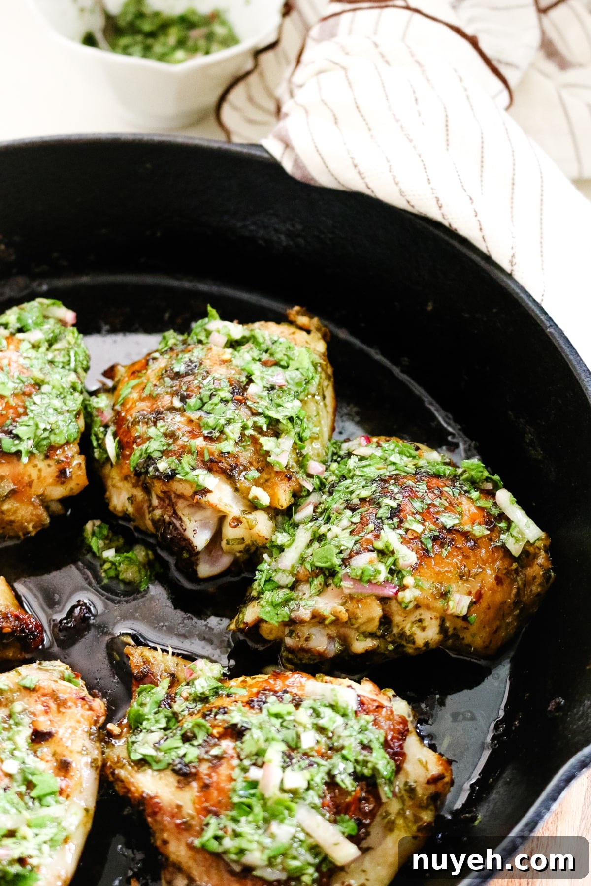 Grilled Chimichurri Chicken Thighs Recipe 5 chimichurri chicken thighs in cast iron skillet.