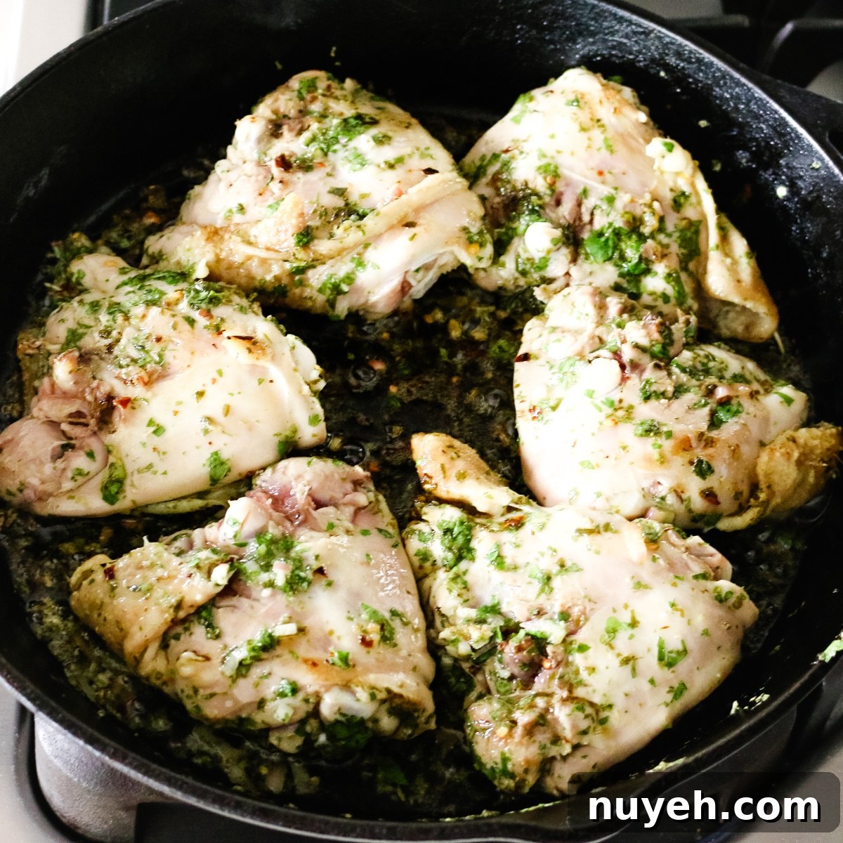 Grilled Chimichurri Chicken Thighs Recipe 8 chimichurri chicken thighs in cast iron skillet.
