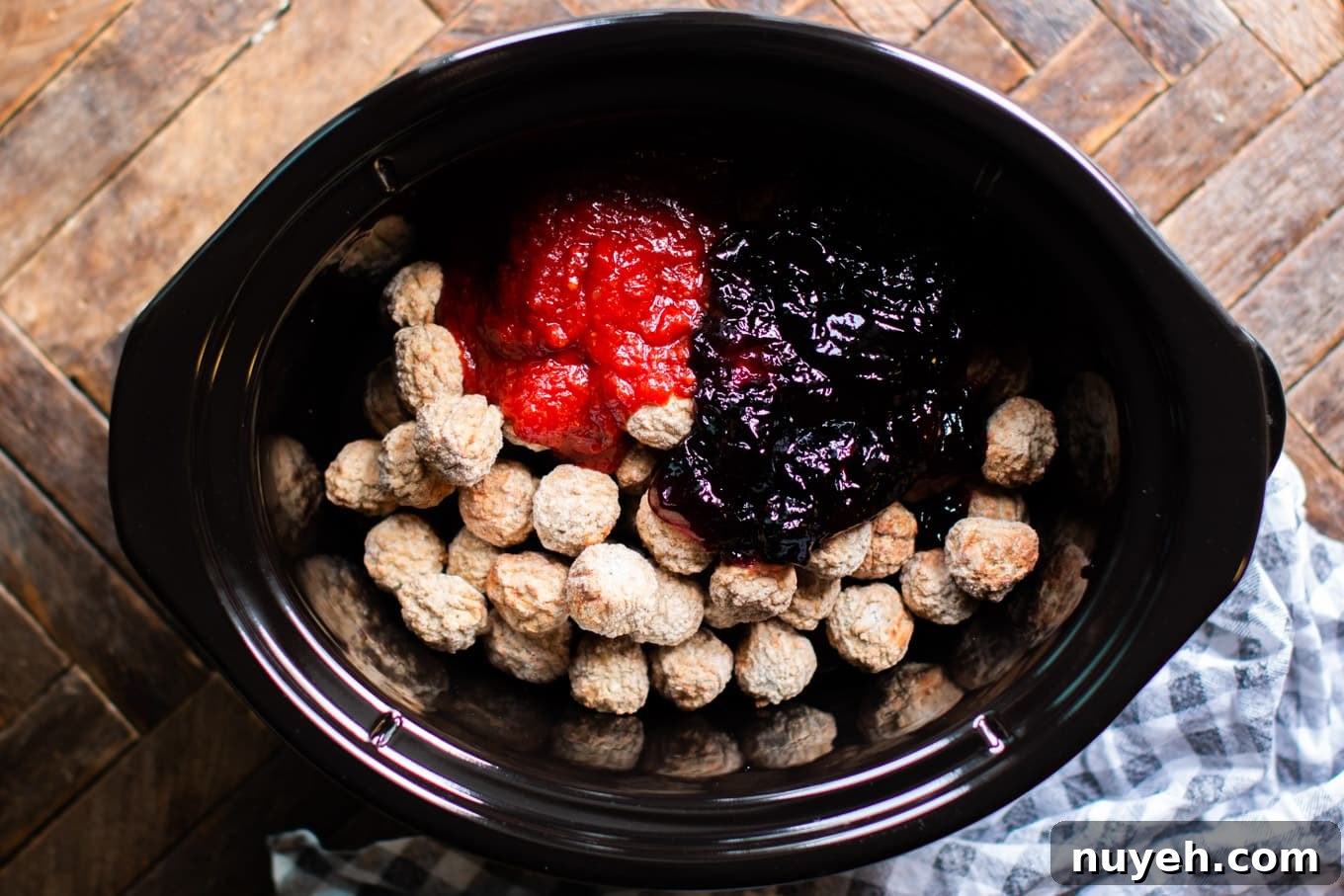 meatballs, grape jelly, heinz chili sauce in crockpot before cooking.