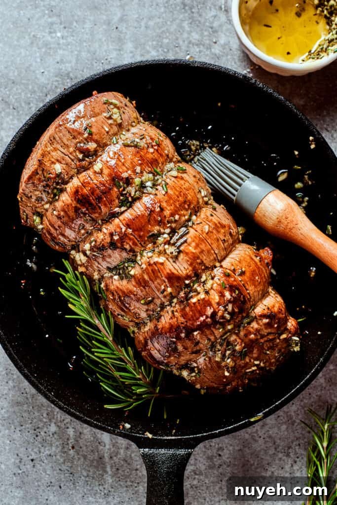Cooked top round roast in a skillet.