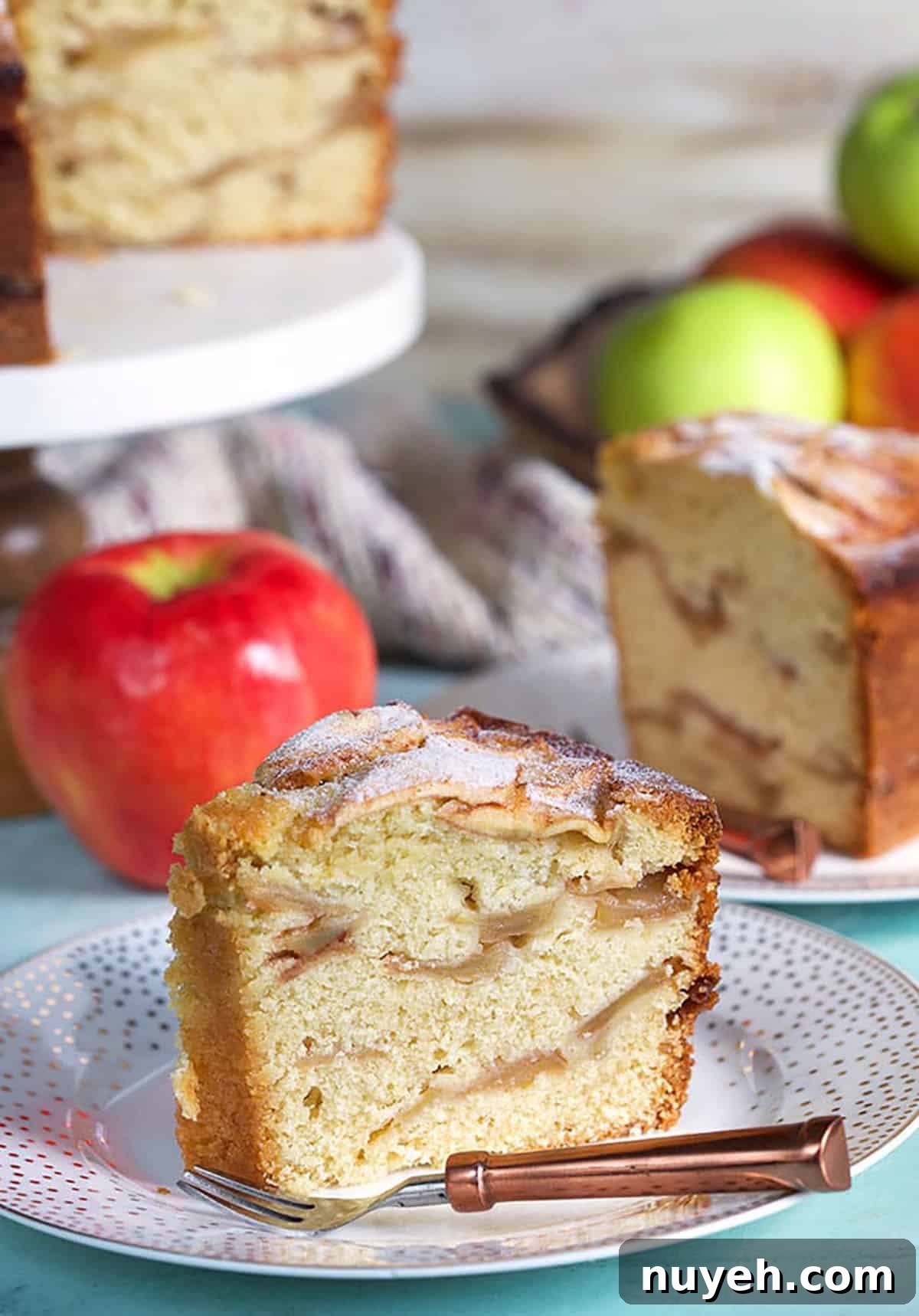 Traditional Jewish Apple Cake Recipe 2 Jewish Apple Cake slice on a white plate with a copper fork.