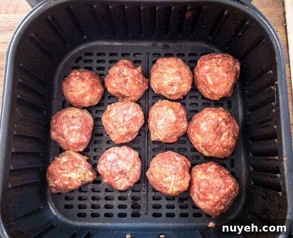 Meatballs in Air Fryer Basket ready to cook.