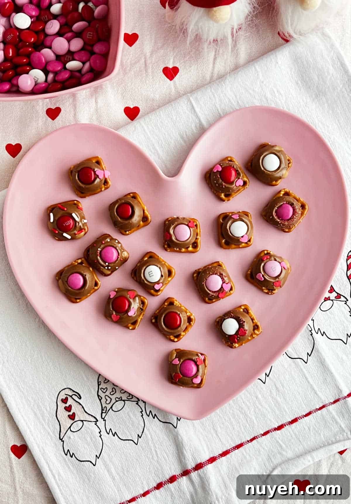 Rolo Pretzel bites on pink heart plate.