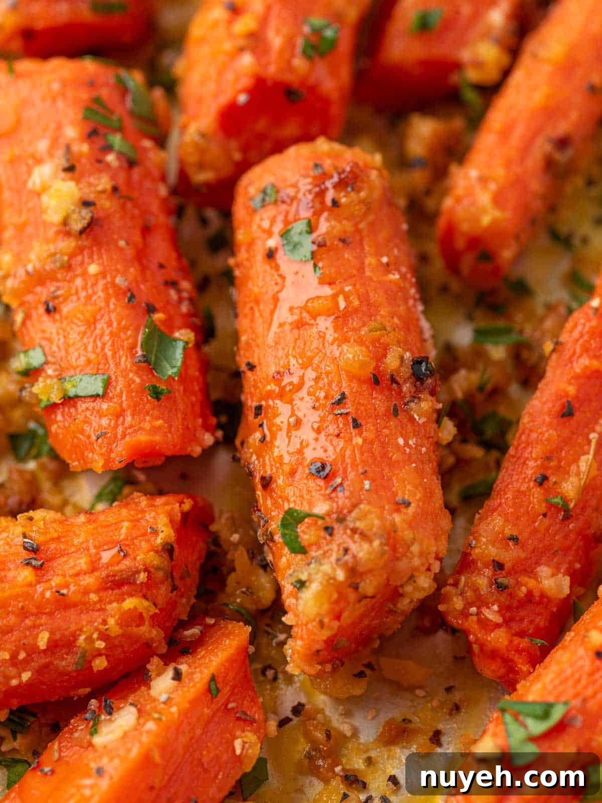 Close up of glazed carrots with parmesan cheese.