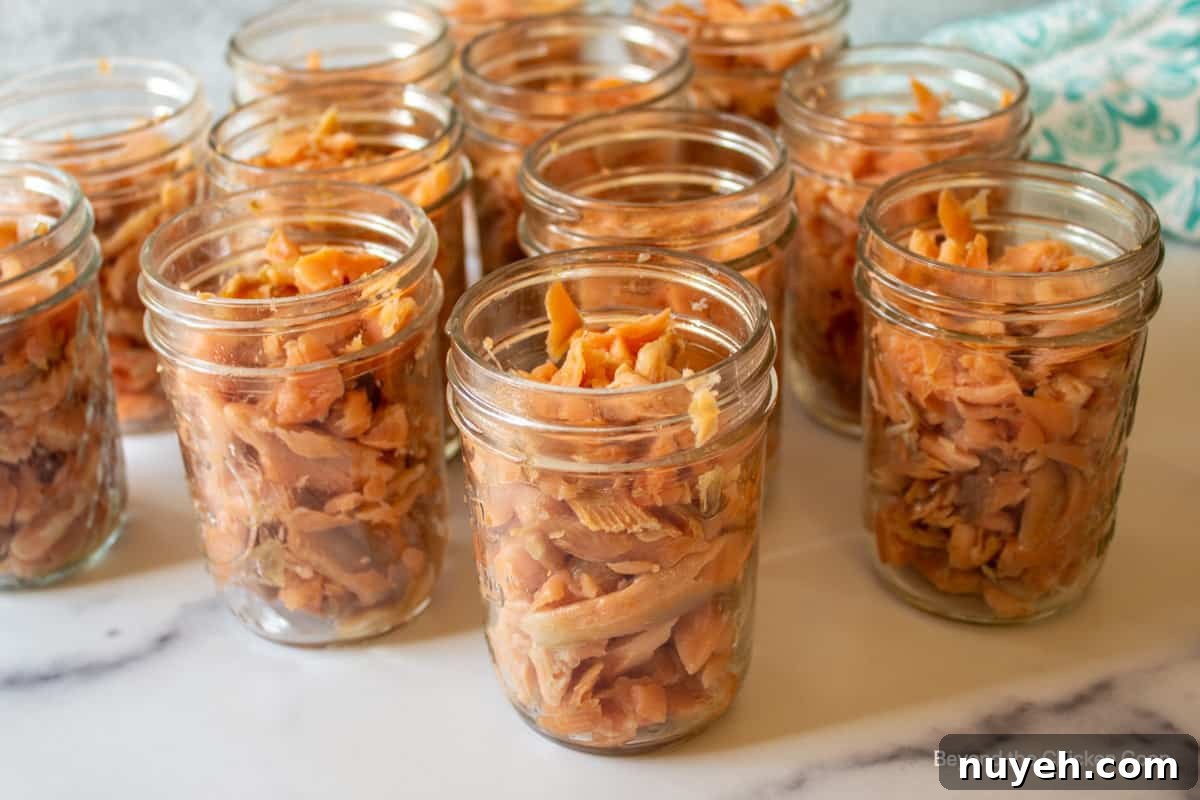 Canning jars filled with smoked fish.
