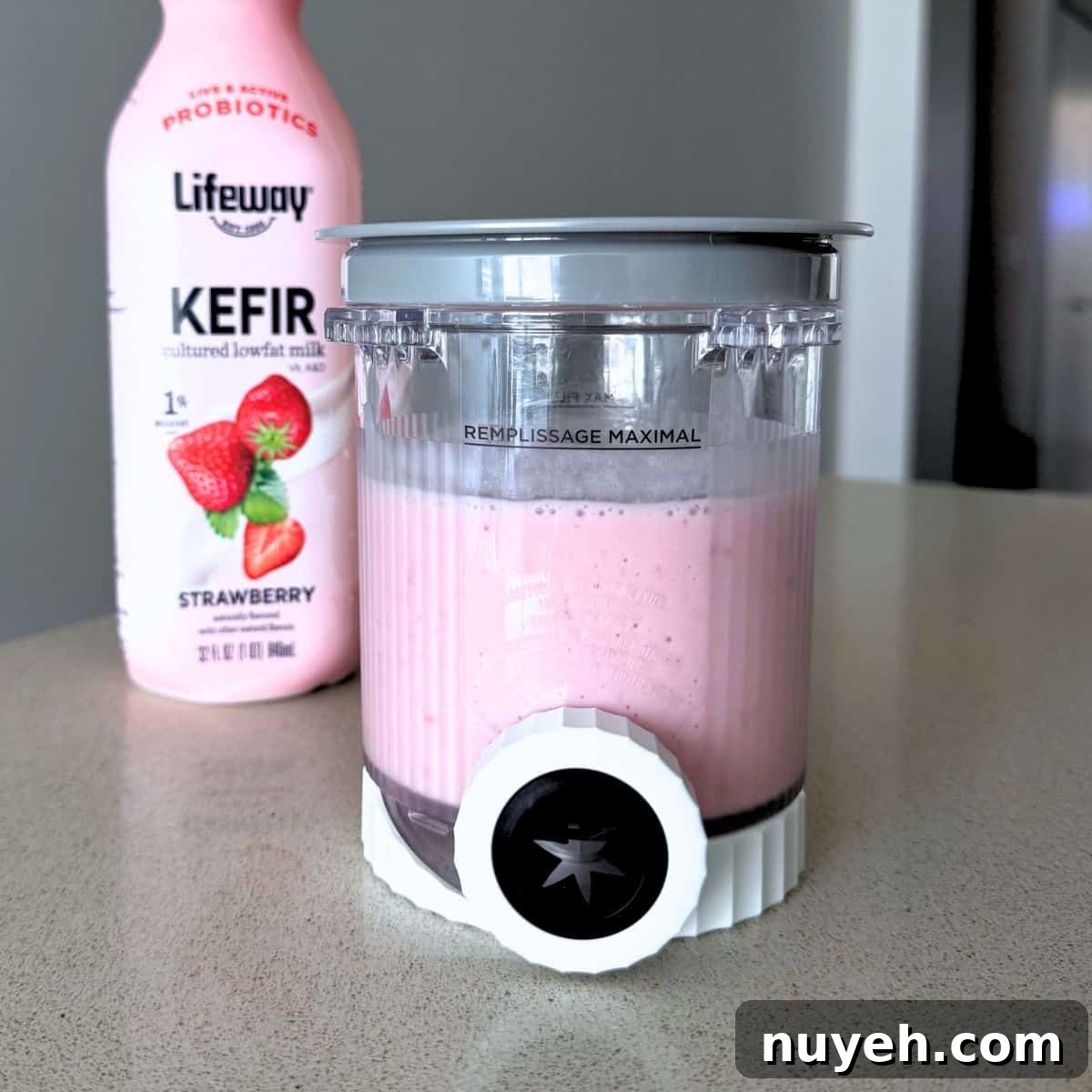 A mixture of strawberries, sugar, and Lifeway strawberry kefir in a Ninja Creami pint.