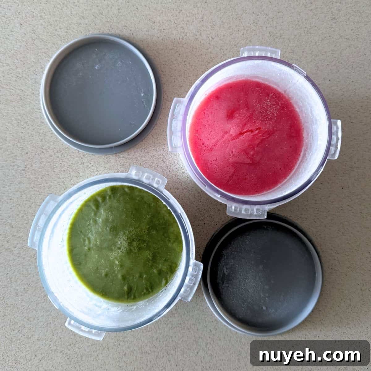 Matcha and strawberry ice cream mixtures frozen in Ninja Creami pints.