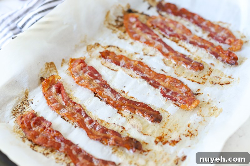Cooked bacon on a baking sheet.