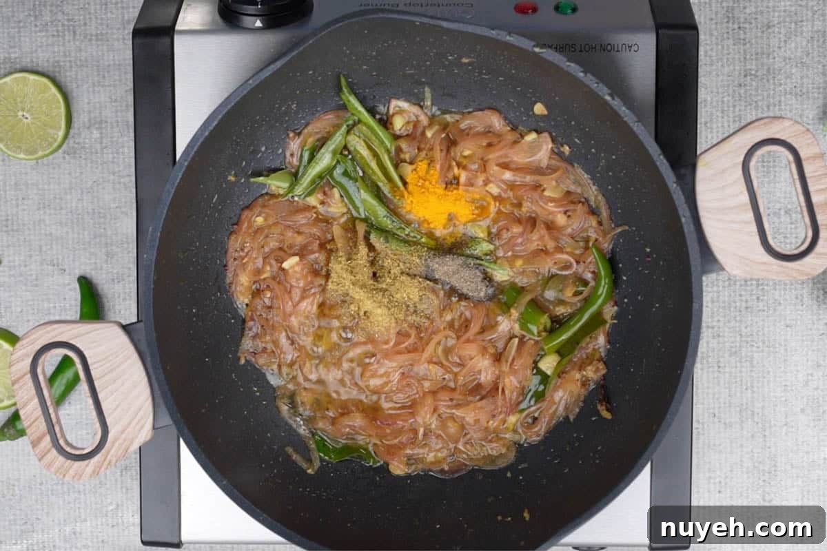 Coriander powder, turmeric powder and black pepper powder added to the pan.