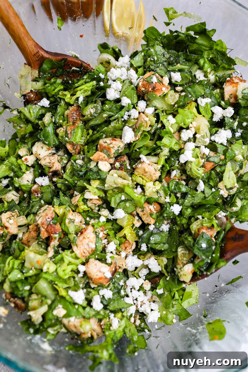 Crisp Chopped Chicken Salad with Feta and Lemon Vinaigrette 3 A close up photo of a large glass mixing bowl filled with chopped chicken feta salad