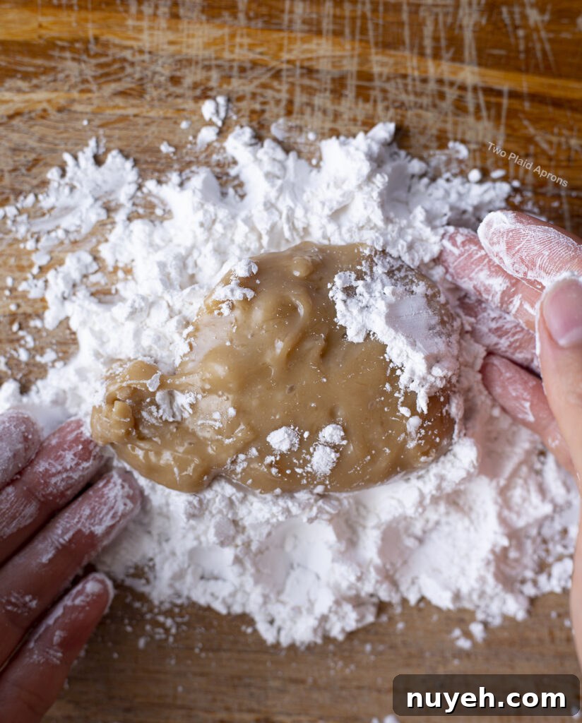Pouring out cooked tapioca dough onto the tapioca flour.