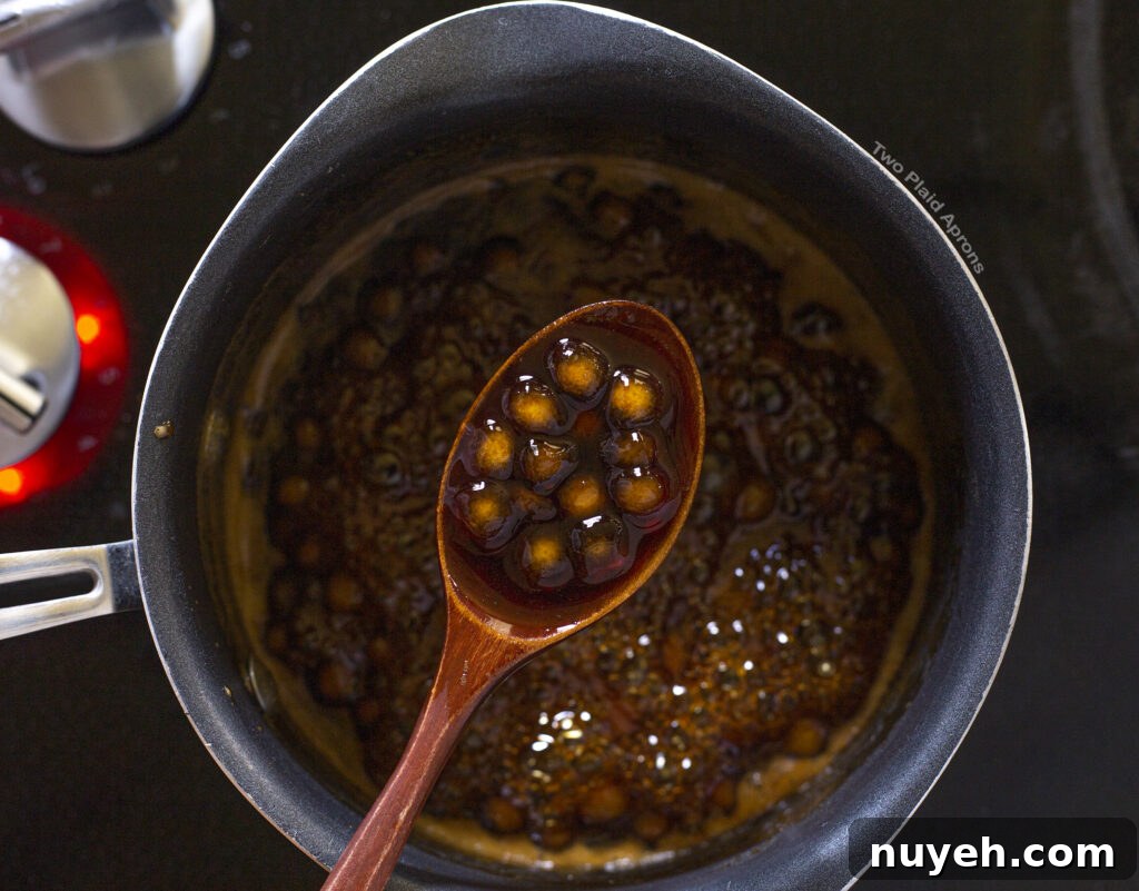 Brown sugar boba cooking in brown sugar syrup.