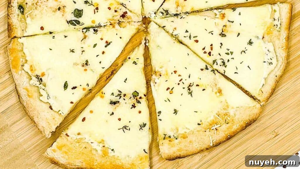 Sliced white pizza on a pizza board.