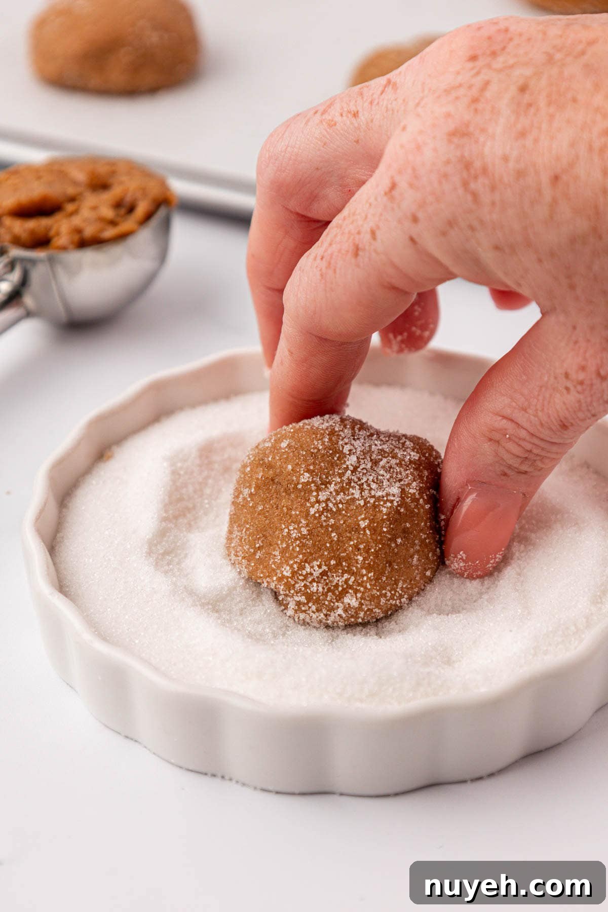 Spiced Cake Mix Cookies Recipe 8 dipping a cookie dough ball into sugar