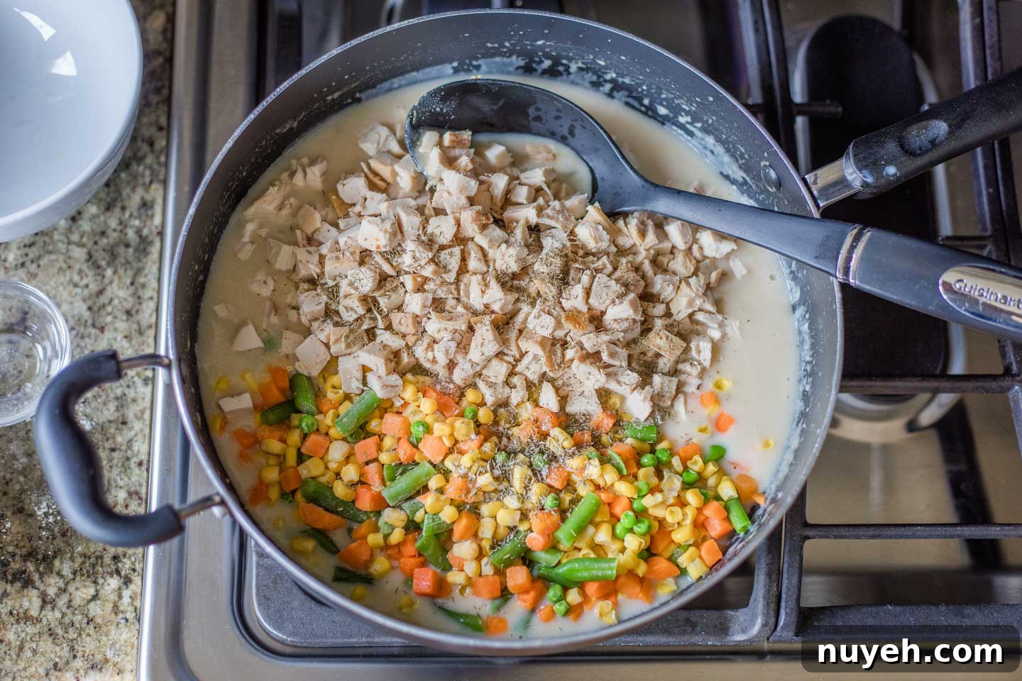 pan with turkey, veggies, and seasonings added onto thickened gravy
