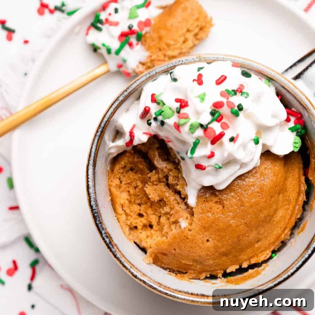 gingerbread mug cake with scoop taken out and spoon sitting on the side