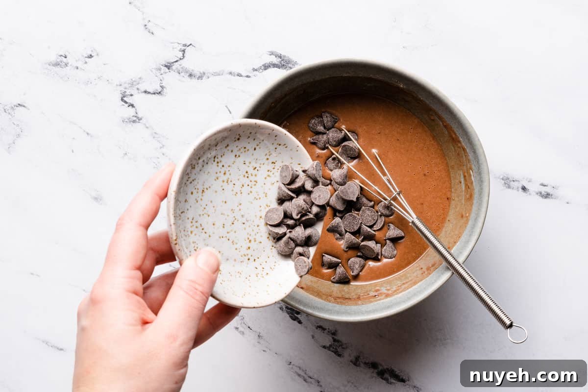 chocolate chips being added into cake batter