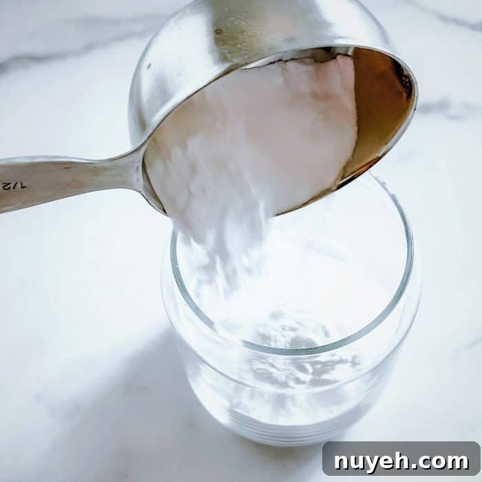 adding baking soda to glass jar
