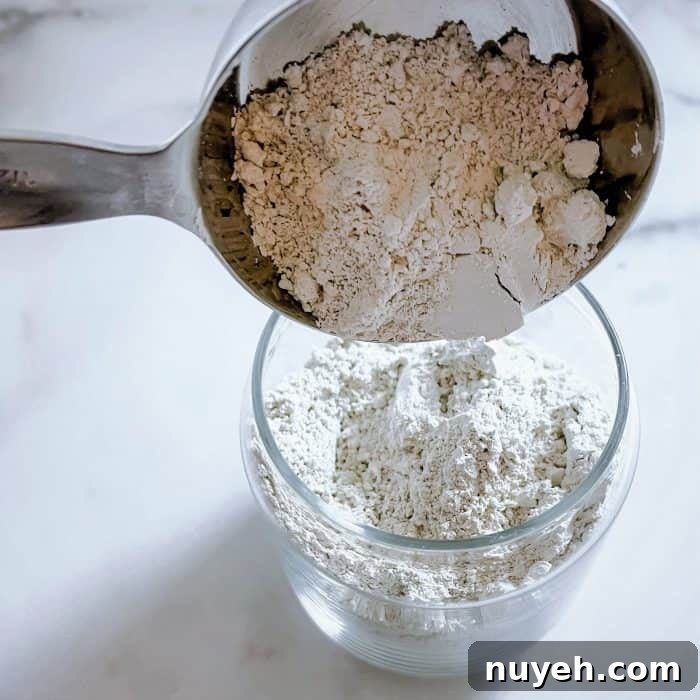 adding food-grade diatomaceous earth to glass jar