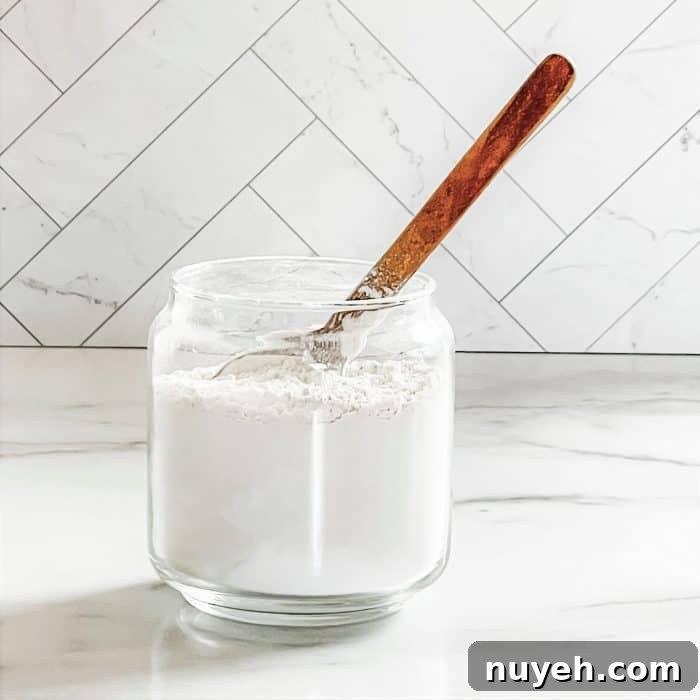using wooden spoon to stir ingredients for homemade refrigerator freshener