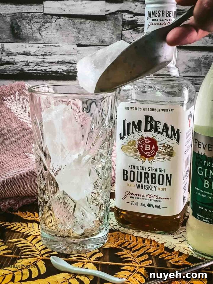 Fill a highball glass with cubed ice.