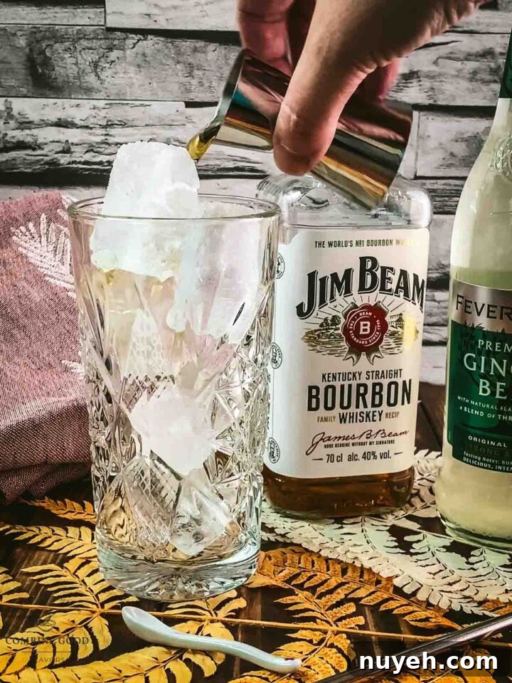 Add Bourbon to the cubed ice filled highball glass.