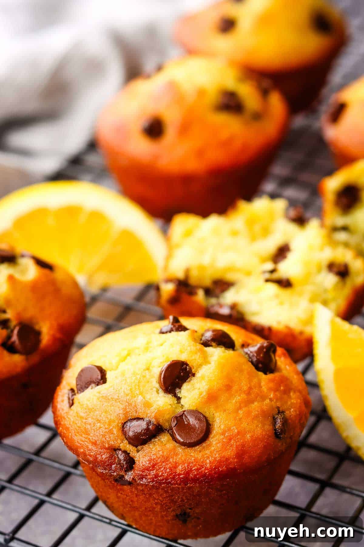 Orange chocolate chip muffins on a cooling rack.