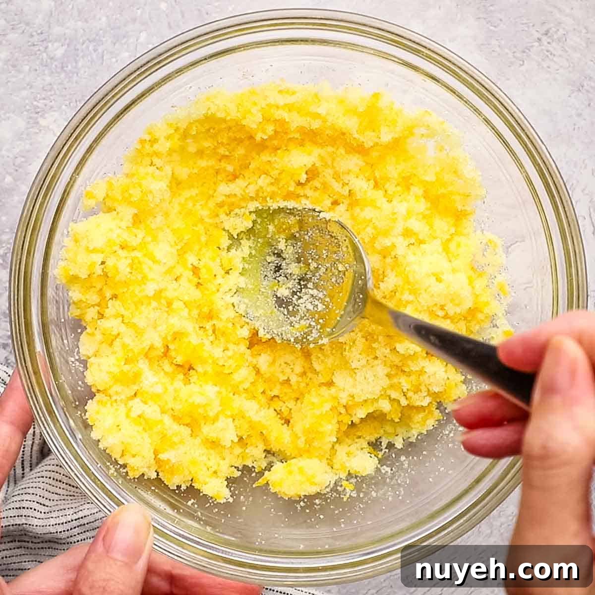 mixing orange zest and sugar in a small bowl