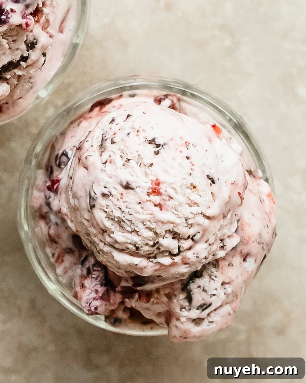Black cherry ice cream is a rich and creamy vanilla ice cream infused with sweet black cherry syrup, chunks of black cherries and chopped chocolate. This no churn cherry ice cream is an easy to make treat everyone will love.