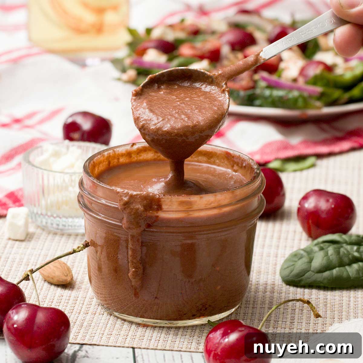 Cherry Compote in 15 Minutes: Dessert Topping Recipe 10 A spoon full of cherry balsamic vinaigrette with fresh cherries.