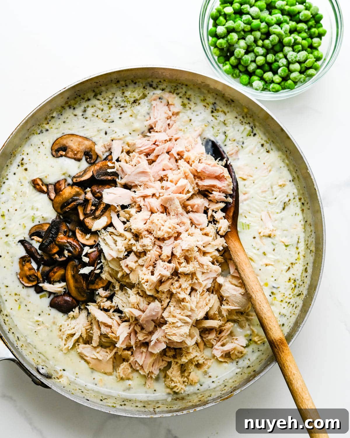 Creamy Tuna Noodle Casserole with Crispy Crumbs 7 Add tuna and mushrooms.