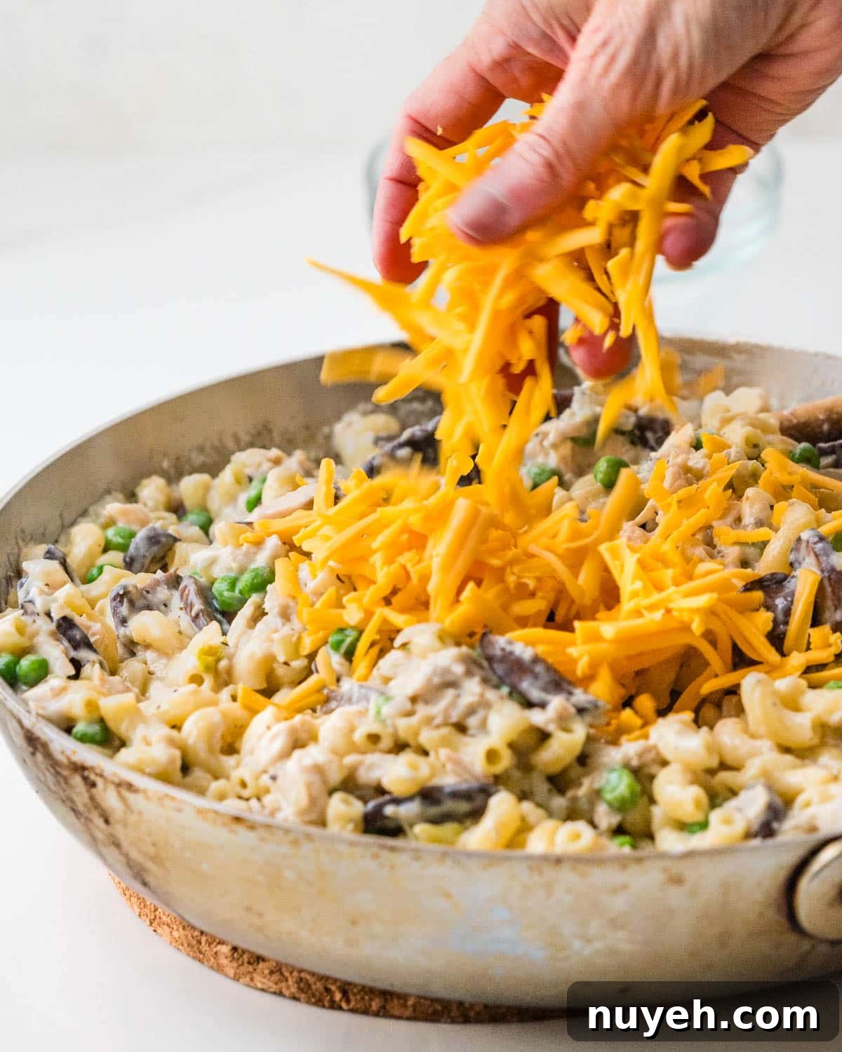 Creamy Tuna Noodle Casserole with Crispy Crumbs 9 Adding cheese to the pasta.