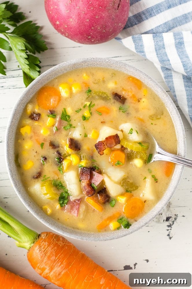 top down shot of a spoon in a bowl of corn chowder
