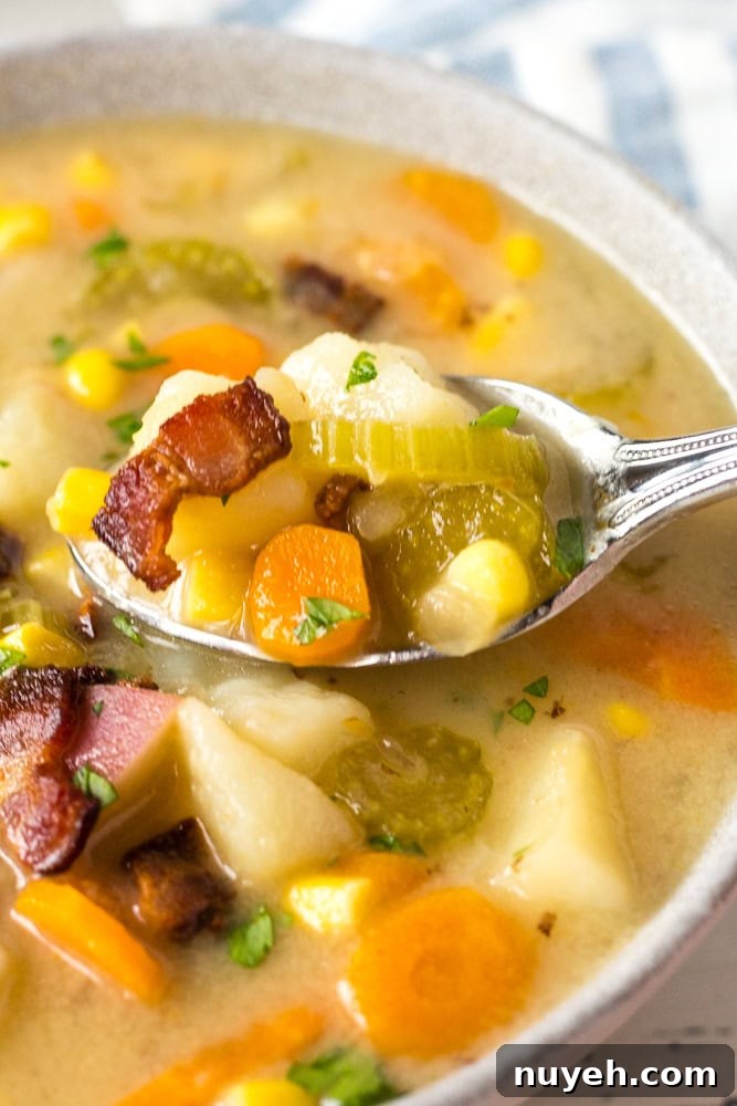 close up of a spoonful of potato corn chowder