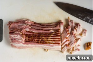 bacon being cut on a cutting board