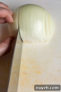 chopping an onion on a cutting board