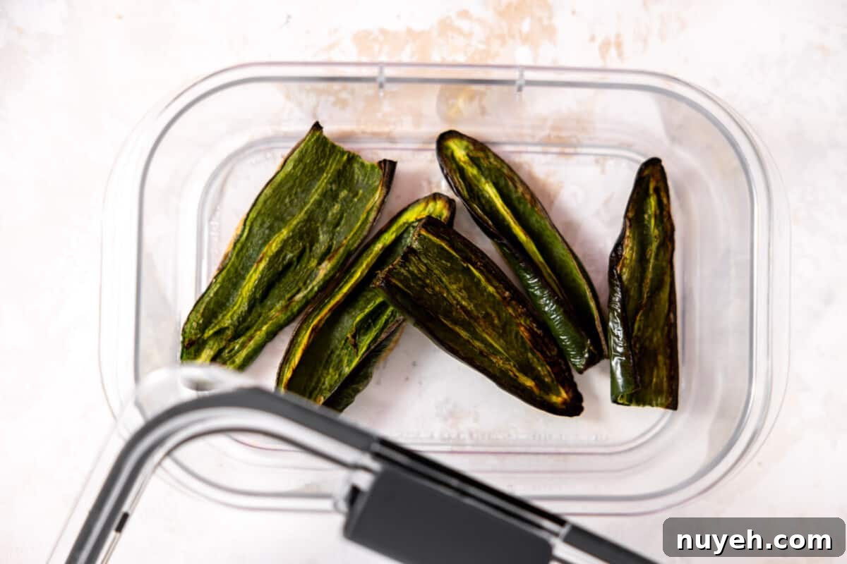 Roasted jalapeños in a container. 