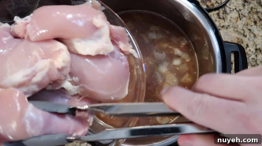 Adding boneless, skinless chicken thighs to pot