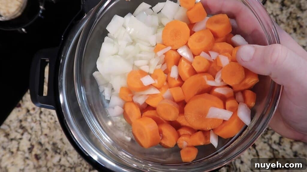 Adding onion and carrots to pot