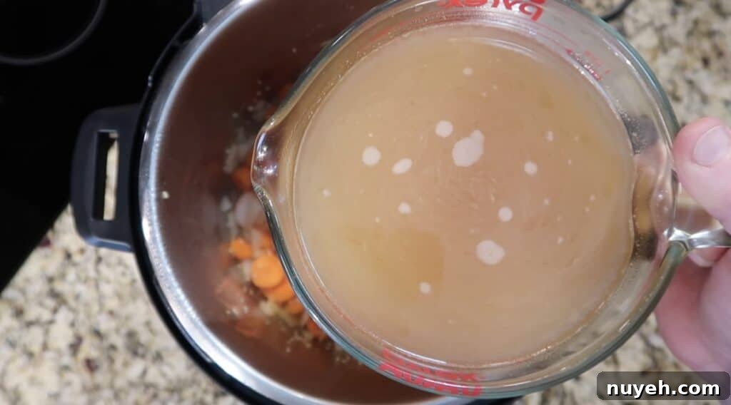 Adding broth to pot