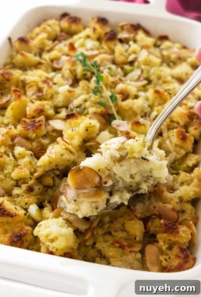 A spoon scooping out some sourdough stuffing.